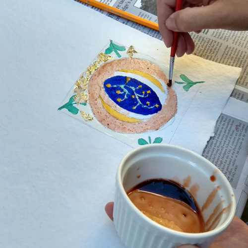 Photograph, UGA students experimenting with making pigments and painting illustrations in the style of medieval manuscripts.