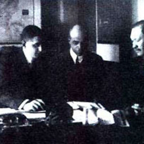 Photograph, Heman Perry (center) discussing business, 1921