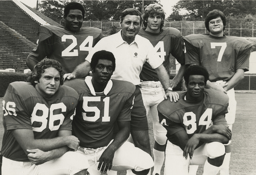 Coach Vince Dooley posing with an integrated group of Georgia football players